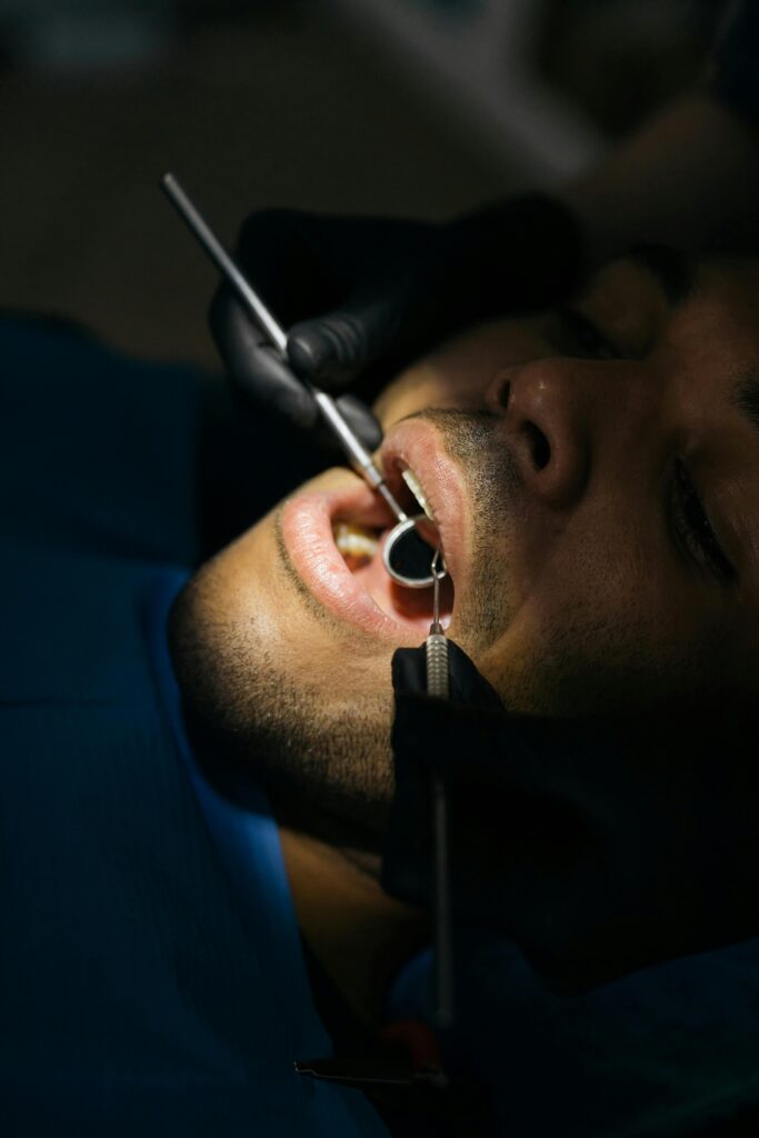 pexels-photo-6502745-6502745 Detailed close-up of a dental examination with a mouth mirror and probe at a clinic.